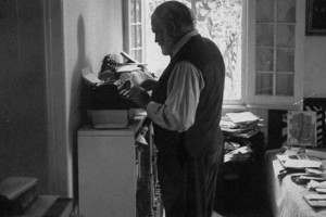 Ernest Hemingway, writing, standing up, presumably in the morning.