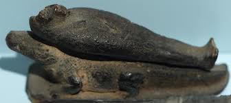 A statuette with Osiris on the back of a crocodile