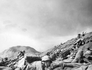 Men of USMC 5th Division advancing through the volcanic ash hills of Red Beach No. 1 at Iwo Jima, Japan, 19 Feb 1945 (US Naval History and Heritage Command)