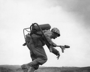 Man of US 9th Marines with flamethrower, Motoyama Airfield (Airfield Number 2), Iwo Jima, Feb 1945 (US Naval History and Heritage Command)