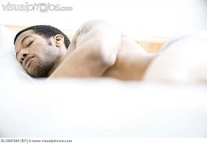 African American man sleeping in bed
