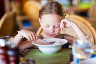 Little girl eating breakfast