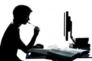 one young teenager boy girl silhouette studying with computer c