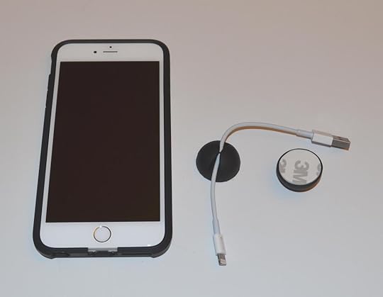 A sample view of the CableButton in use and size comparison with the Apple iPhone 6 Plus.
