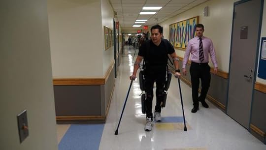 Robert Woo (L) walks using the ReWalk