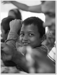 Ecuador -- Together with his father, siblings and cousins, this young Columbian refugee gets a taste of home from his aunt's cooking.