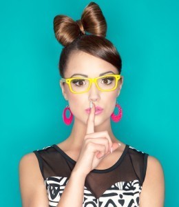 Young attractive fashionable woman with finger on lips