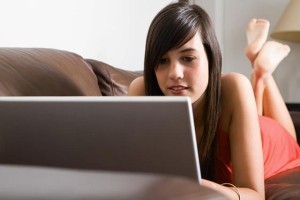 Teenage girl using laptop