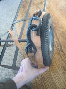 Wrap ratcheting strap around tire