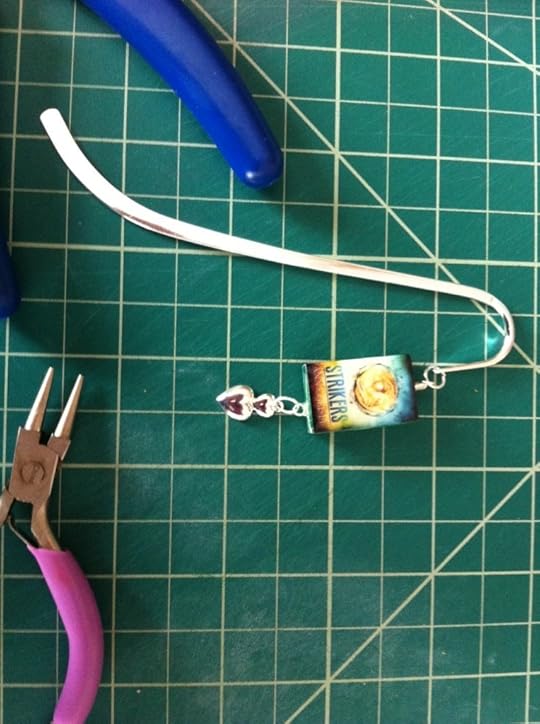 This one is the simplest example of a bookmark. A single eyepin with a charm at the bottom attached via a jumpring. At the top the bookcharm is attached to the bookmark via another jumpring. A crimp tube was used to secure the loop I made in the top of the eyepin.