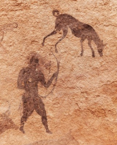 paleo man and dog working together