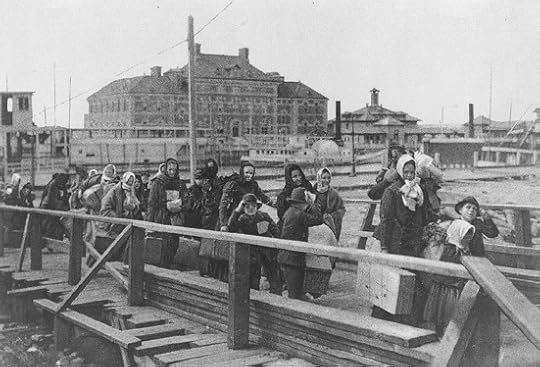 Emigrants coming up the board-walk from the barge, which has taken them off the steamship company's docks, and transported them to Ellis Island. Public domain via the Library of Congress.