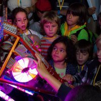 Young Maker Faire 2013 attendees interacting with Russel the Electric Giraffe