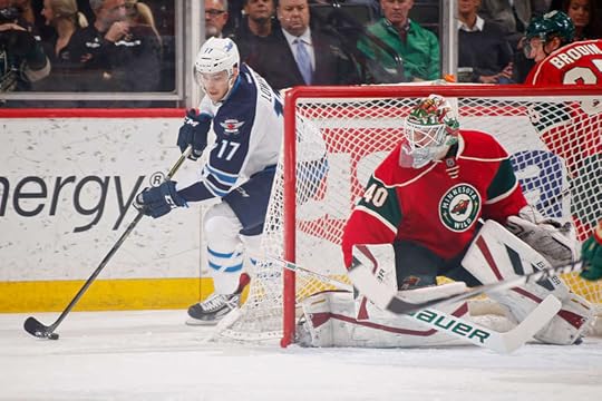 The Wild's Devan Dubnyk watches for the Jets' Adam Lowry