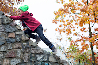 boy climbing on wall