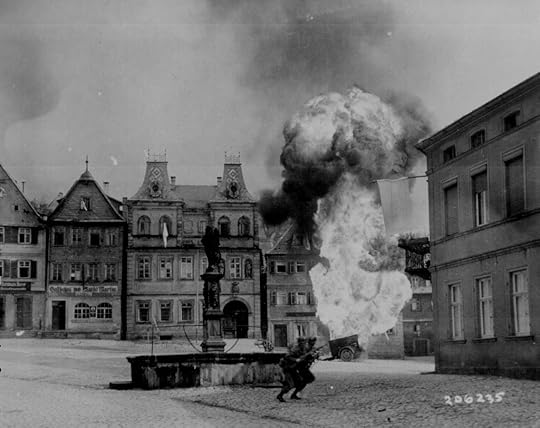 Men of US 101st Infantry Regiment running past a burning fuel trailer in square of Kronach, Bayreuth, Germany, 14 Apr 1945 (US National Archives)