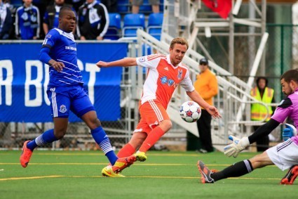 Matt Van Oekel, right, robs Carolina's Mark Anderson as FCE defender Mallan Roberts tries to get a foot in. PHOTO: FC EDMONTON/TONY LEWIS