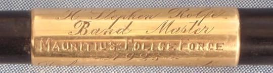 Part of the dedication inscribed on a gold band on the baton.