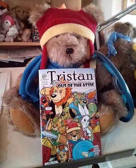 Tristan the Teddy Bear holding his latest comic Out of the Attic