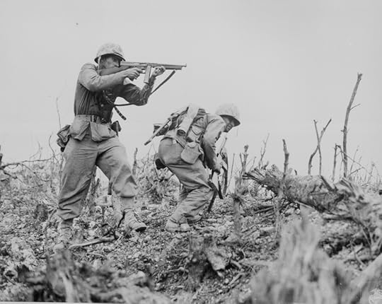 A Marine of the US 1st Marines Division pointed his Thompson submachine gun at a Japanese sniper, Okinawa, Apr-Jun 1945 (US National Archives)