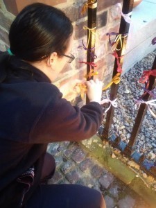 Sarahleigh ties a prayer ribbon at Leicester Cathedral