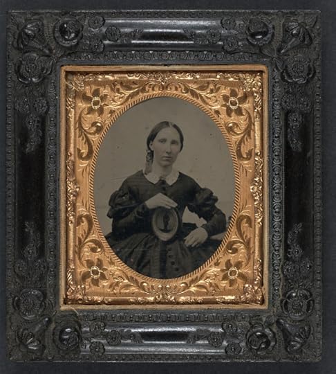 A woman in mourning clothes holds an image of her husband during the Civil War (Library of Congress)