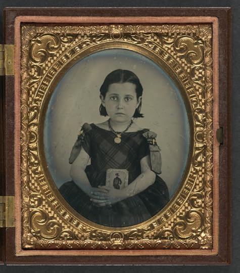 A girl in mourning clothes holds an image of her father during the Civil War (Library of Congress)