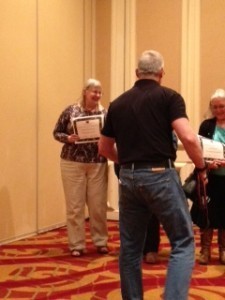 Photographer looks like he is attacking Kaitlyn Dunnett after she gets her nominee certificate