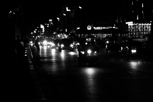 The road around the moat at night. A busy tree-lined street that is always full of motorbikes and tuk tuks.