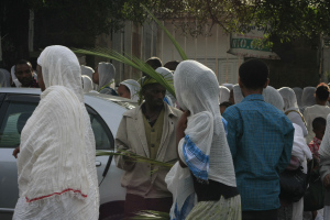 Street vendor selling imported palm fronds to the devout.