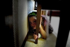 Child hiding under table