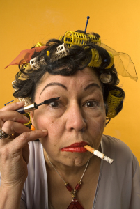 old woman applying makeup