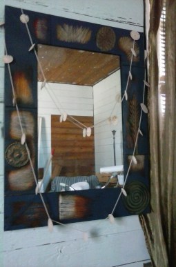 Hand painted mirror with sand dollar garland.