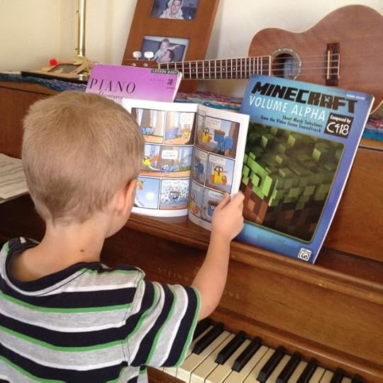reading comics at the piano