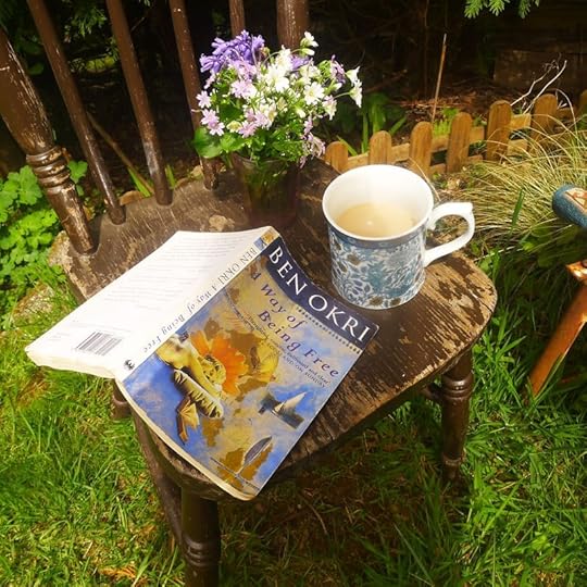 Still life of wildflowers, coffee, and book
