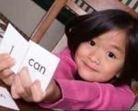 Young child showing words I Can!