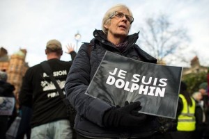 A demonstrator holds a placard during a rally in London to protest Taiji’s annual slaughter of dolphins in January.