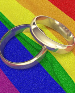 Wedding rings on rainbow coloured cloth