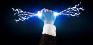 Business person holding electrical powered wires concept on background