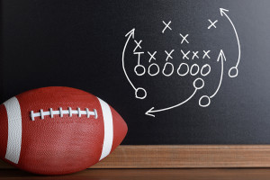 Football Play Strategy Drawn Out On A Chalk Board