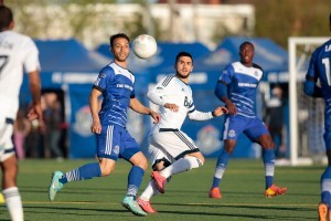 FC Edmonton's Cristian Raudales heads the ball away from Whitecap Pedro Morales. PHOTO: TONY LEWIS/FC EDMONTON