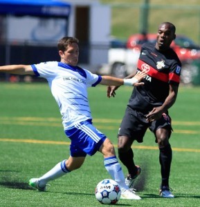 BURT AND CUMMINGS: FCE's Chad Burt, left, and Scorpion Omar Cummings battle for the ball. PHOTO TONY LEWIS/FC EDMONTON