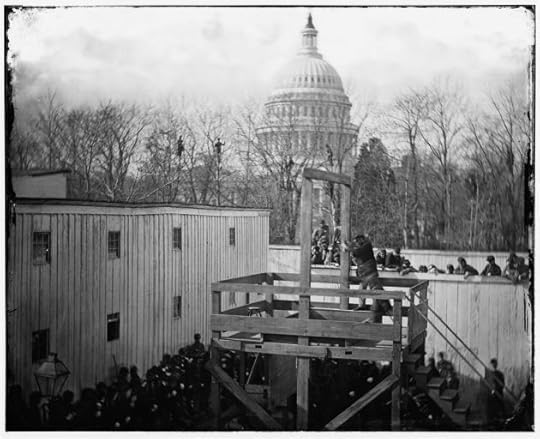 A soldier springs the trapdoor, with men looking on from the trees beyond (Library of Congress)