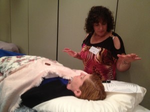 Roseanne is using Hands in Motion to remove energetic debris in client's field. 