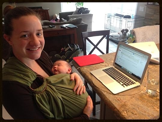 Here I am working with Julia in the Ring Sling. Note the laptop desk behind my computer, and the iPad (red case) to the side. All essential tools in my work day.
