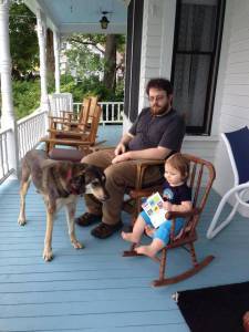 Even at one, my granddaughter understood the joy of reading on the porch.