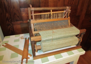 Small table loom with fabric for homegrown, handspun cotton vest.