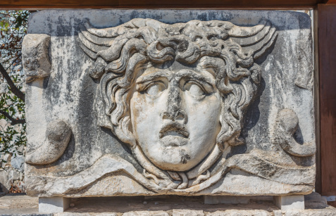 Part architrave with a frieze with mythical Gorgon Medusa head in ancient Temple of Apollo in Didim, Turkey