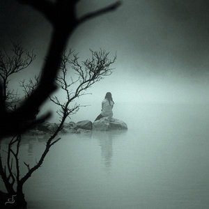 woman alone at the edge of water