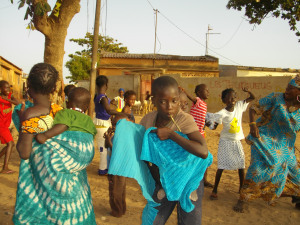 children dancing onstage goats in background